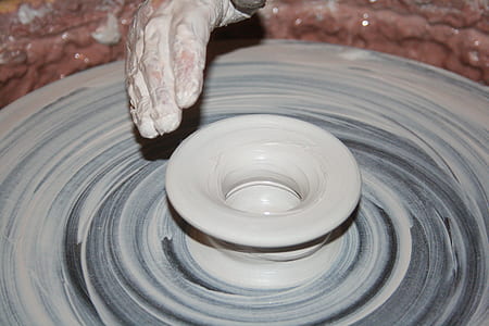 person holding clay pot thumbnail