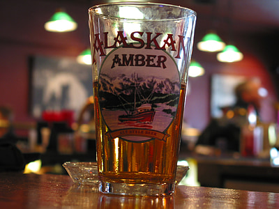 Alaskan Amber beer drinking glass on table top thumbnail