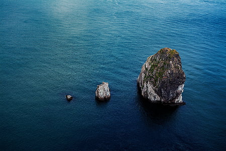rock formation on body of water thumbnail