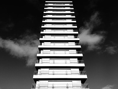 white concrete high rise building on sunny day grayscale photo thumbnail