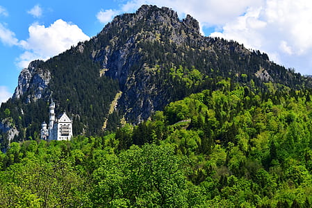 green and black high mountain under blue and white sky at daytime thumbnail