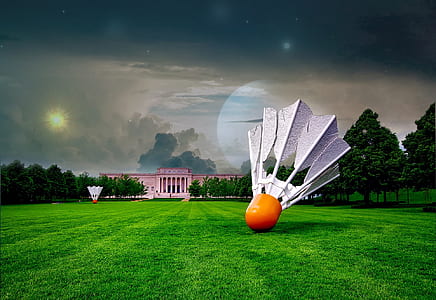 white and orange shuttlecock on grassfield thumbnail