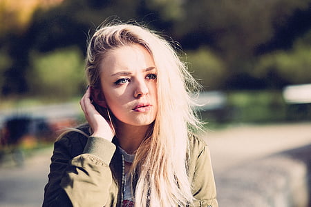 shallow focus photography of woman in brown jacket thumbnail
