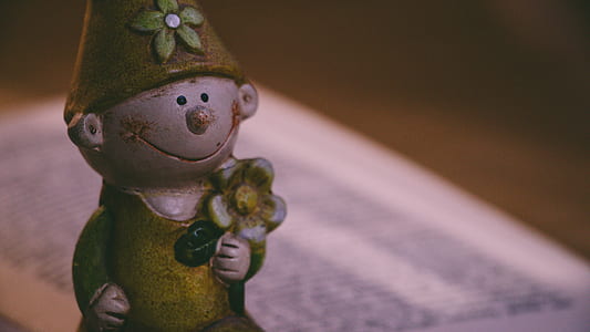 Closeup Photo of Boy Holding Flower Figurine thumbnail