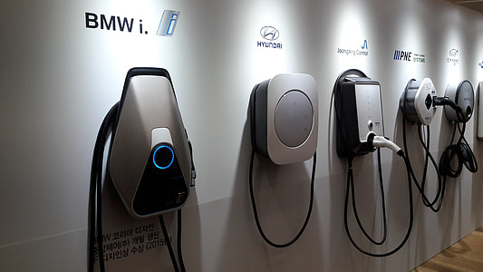 five assorted-color corded electronic devices on white wall thumbnail