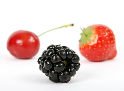 oval black fruit near cherry and strawberry fruit thumbnail