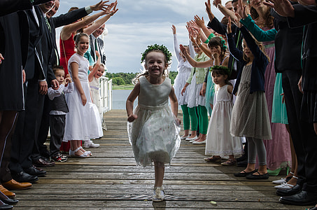 girl in white sleeveless dress running on a bridge thumbnail