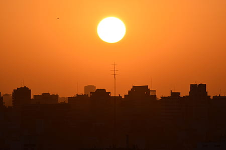 silhouette of buildings during sunrise thumbnail