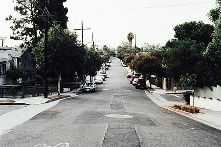 road between building under gray sky thumbnail