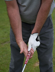 person holding golf putter thumbnail
