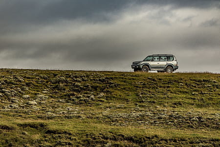 gray SUV under white and black clouds thumbnail