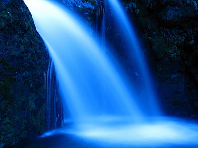 waterfall inside cave during night time thumbnail