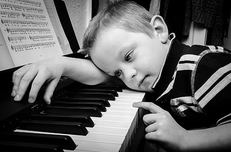 boy leaning on piano keys thumbnail