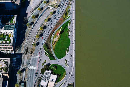 aerial view of city buildings near body of water thumbnail