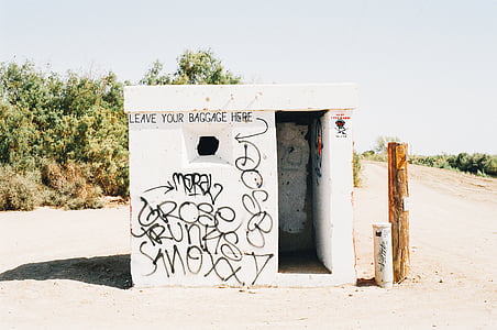 white concrete shed near trees thumbnail