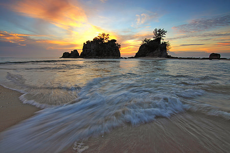 rock formation on body of water thumbnail