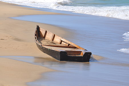brown jon boat on sea shore thumbnail