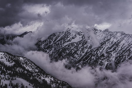 snow covered mountains under white cloudy sky during daytime thumbnail