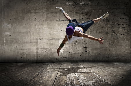 man in white tank top and purple cap doing stunt thumbnail