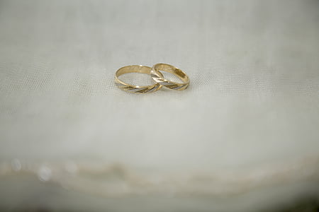 close up photography of two gold-colored rings thumbnail
