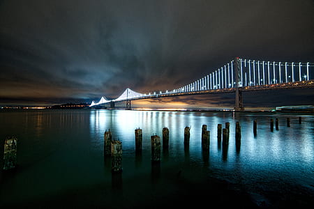 gray concrete bridge near city at nighttime thumbnail