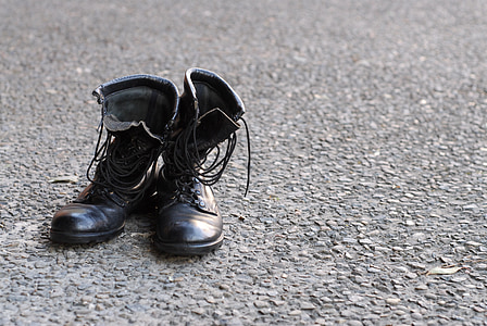 black leather combat boots on gray surface thumbnail
