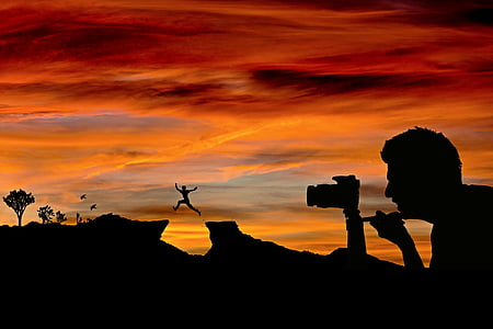 silhouette of man using camera during sunset thumbnail