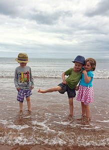 three toddler standing on beach thumbnail