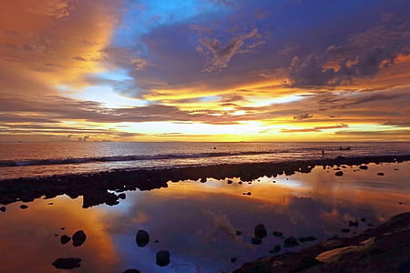 stone and ocean in sunset photo thumbnail