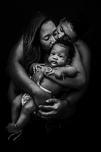 man and woman hugging baby grayscale photo thumbnail