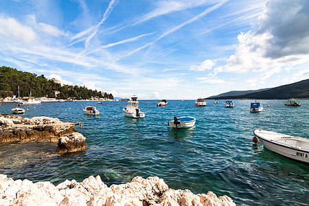 several yachts at dock under sky with clouds thumbnail