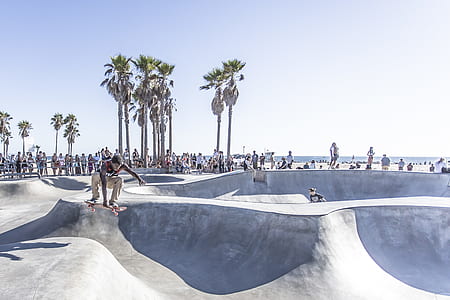 man performing skateboard trick in skateboard near seashore thumbnail