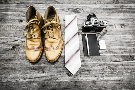 pair of beige boots, grey necktie, and black SLR camera thumbnail