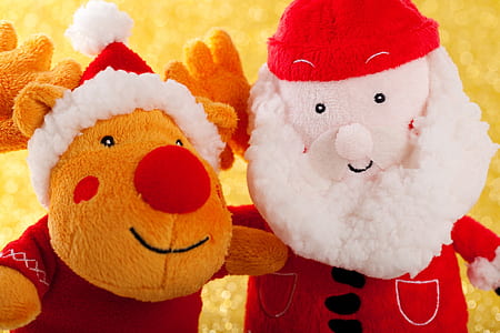 two orange reindeer and Santa Claus plush toys on yellow surface thumbnail