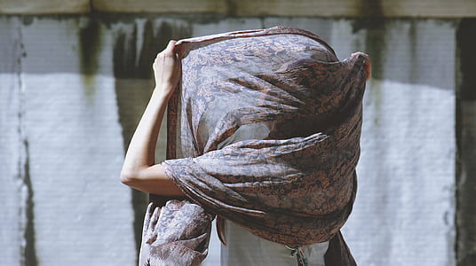 person covering head using scarf thumbnail