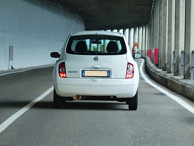 white Nissan Micra passing through road thumbnail