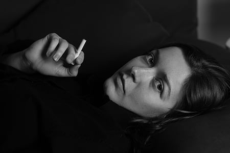 woman holding white cigarette stick thumbnail