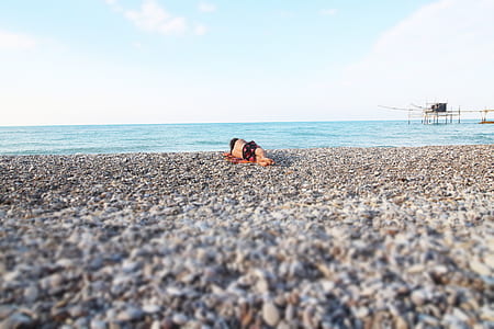 man lying on seashore thumbnail