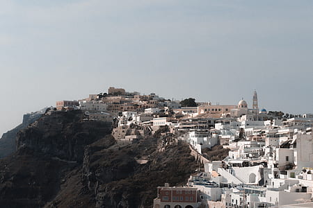 white concrete building near mountain at daytime thumbnail