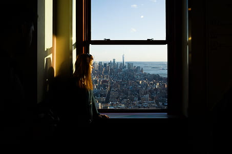 woman standing near sash window thumbnail