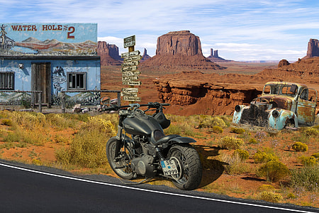 black motorcycle beside road thumbnail
