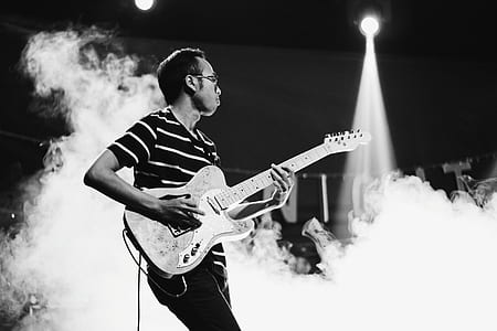 grayscale photo of man playing guitar thumbnail