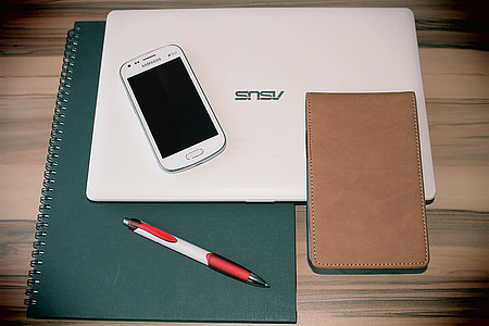white Samsung Android smartphone on white Asus laptop thumbnail