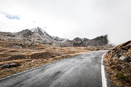 gray road near mountain range thumbnail