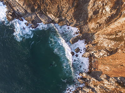 landscape photography of cliff and sea waves thumbnail