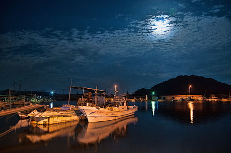 white yacht on body of water during night time thumbnail