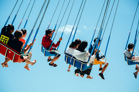 people riding carnival rides at daytime thumbnail