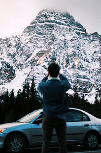 Photographer taking picture of a mountain in Banff National Park, Alberta, Canada thumbnail