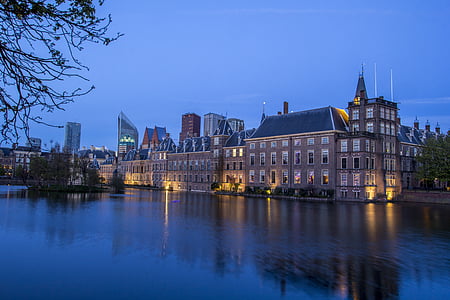 gray building beside body of water thumbnail