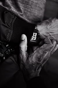 greyscale photo of person wearing Apple Watch reading 13:25 thumbnail